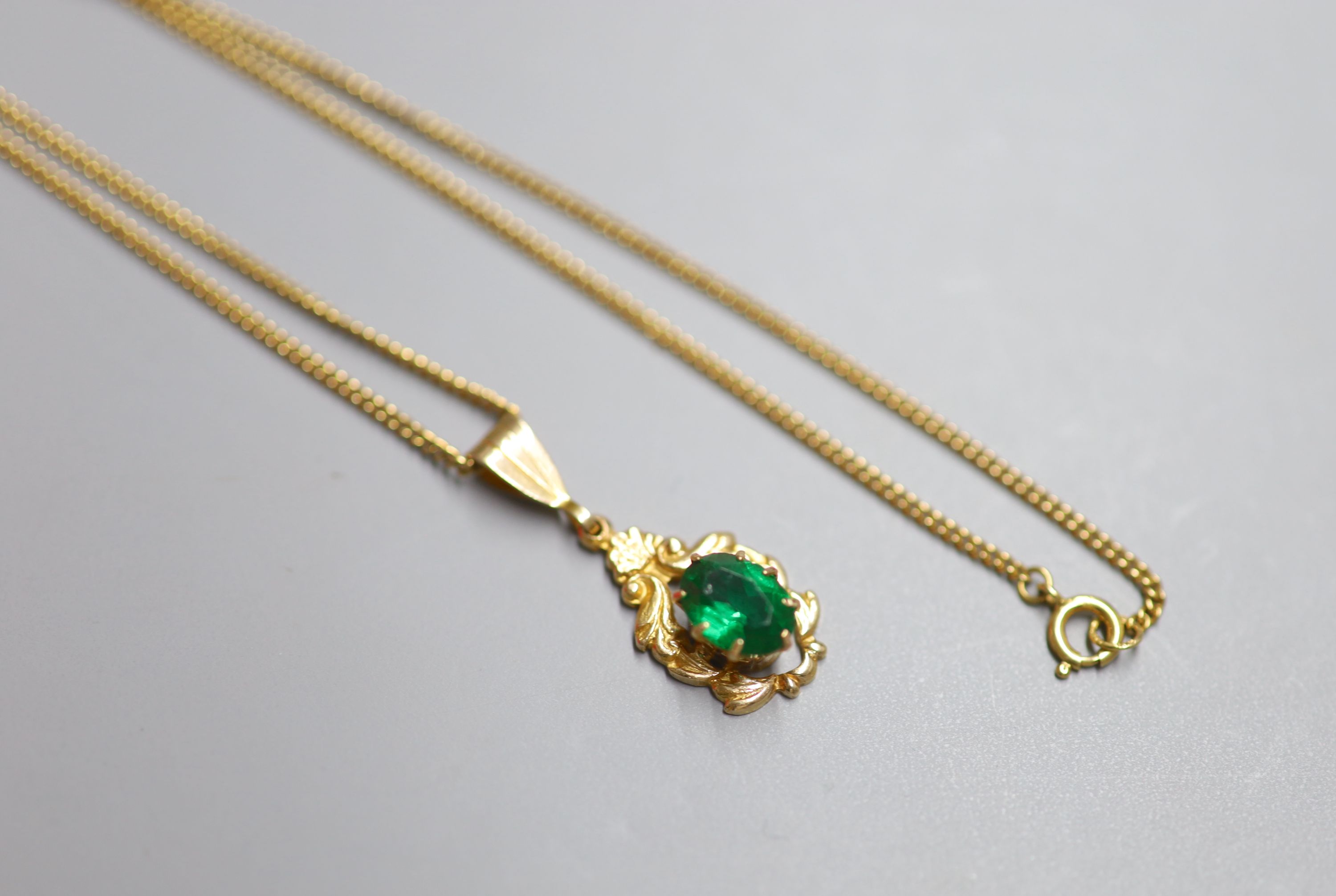 A modern 9ct gold and green paste set pendant, 20mm, on a 9ct gold chain, 50cm, gross 4.7 grams.